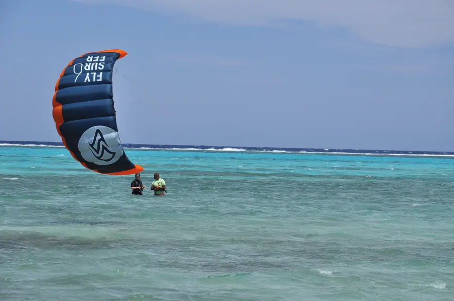 Kite flying low over the calm lagoon water