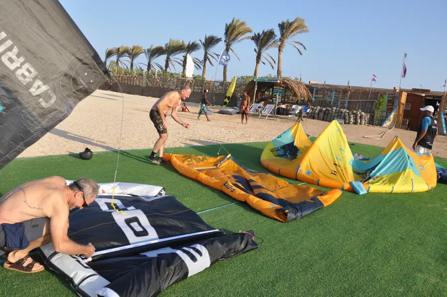 Kites and gear laid out on the grass at the KiteMood base in Marsa Alam