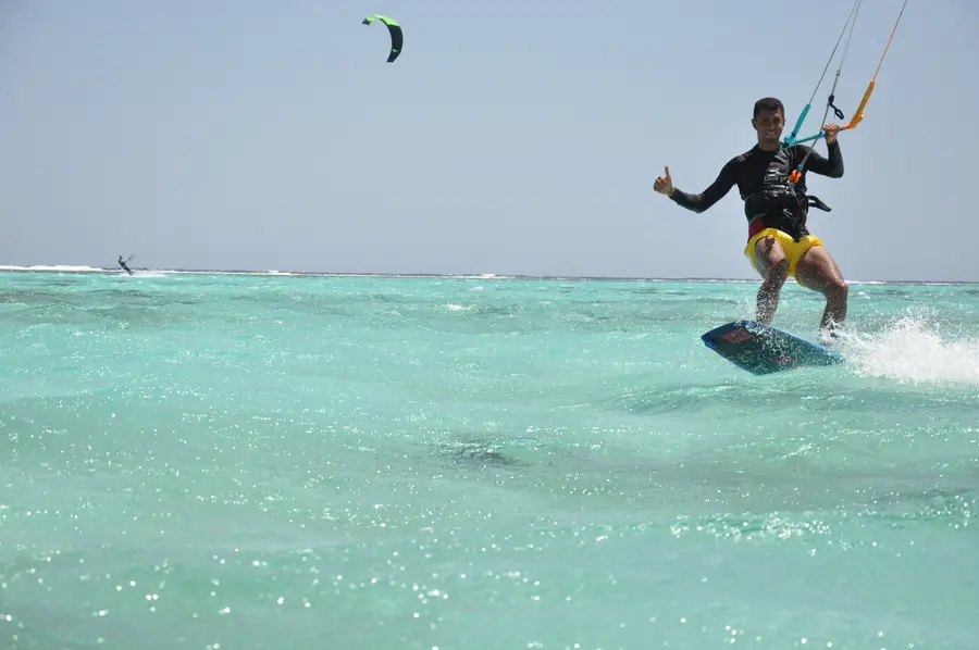 Kitesurfer gliding through the turquoise lagoon at KiteMood Marsa Alam