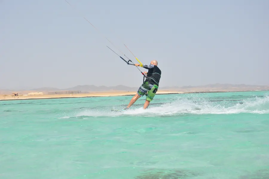 Kitesurfer jumping above the shallow Red Sea lagoon at Marsa Alam